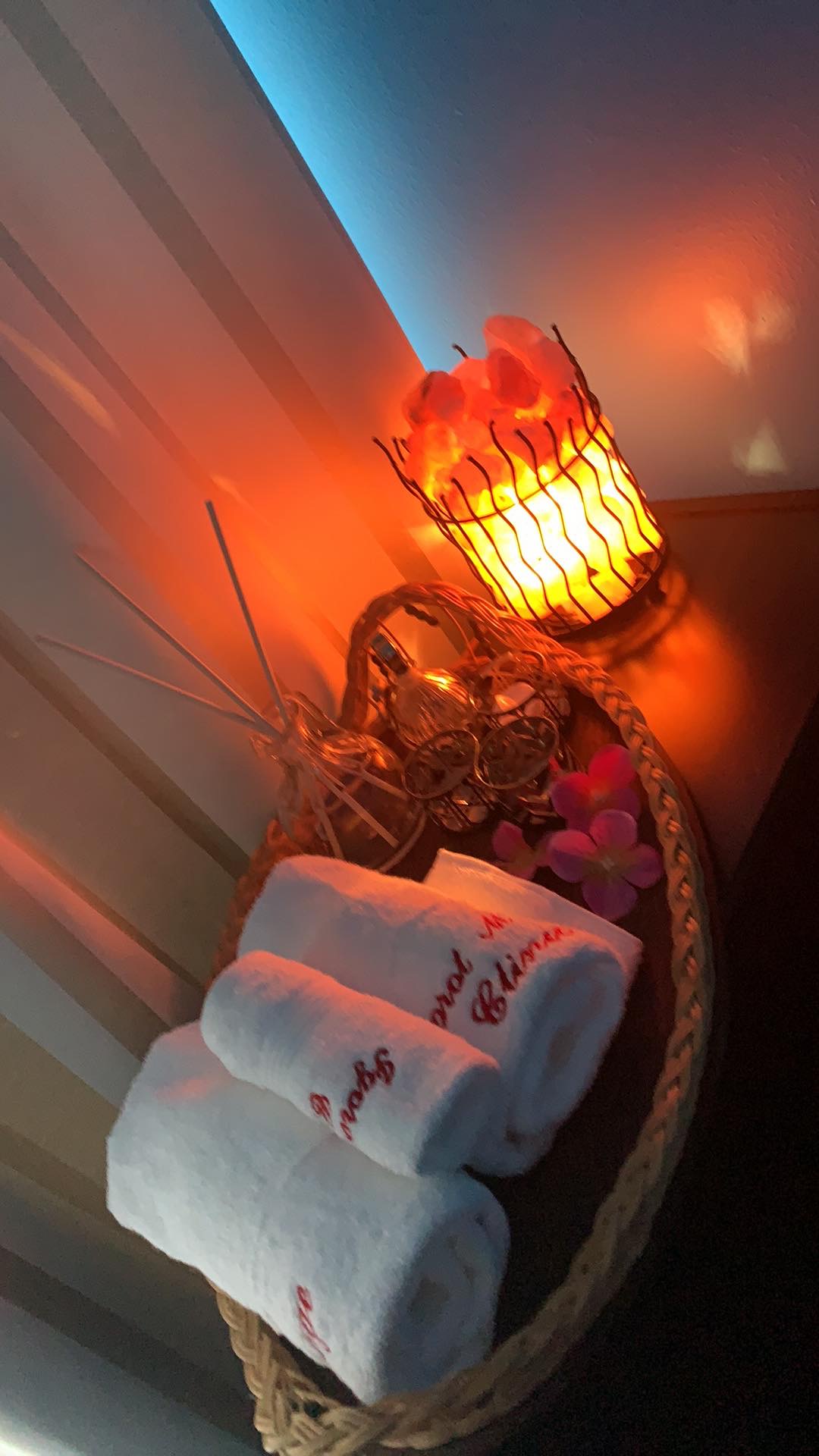 Himalayan salt lamp and rolled towels at Igorot Massage Clinic